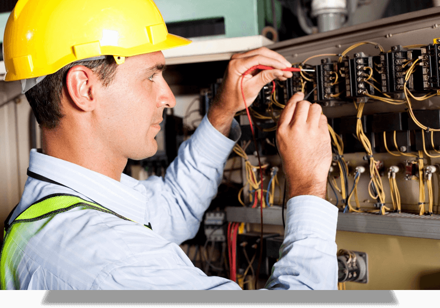 Male Professional Electrician Testing Industrial Machine