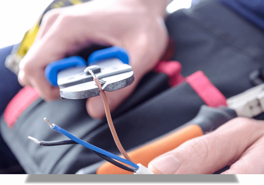 Worker's Hands Cutting Electric Wires With Pliers